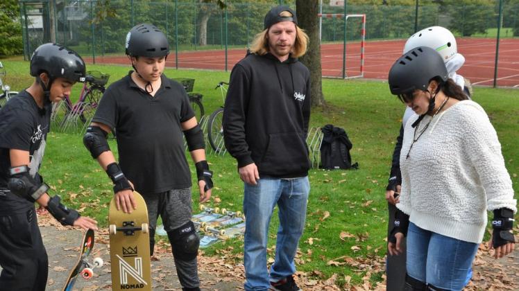 Sascha Richwin (Mitte) von der Skatewerkstatt Delmenhorst führt die Schüler am ersten Termin der Skateboard-AG an der Oberschule Süd in die Grundlagen des Skateboardens ein.