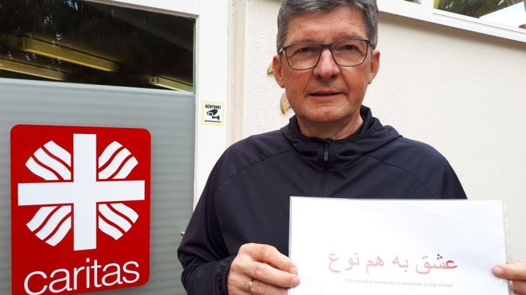 Caritasdirektor Franz Loth mit dem Solidaritätsgruß an afghanische Menschen: Der Farsi-Schriftzug bedeutet auf Deutsch „Nächstenliebe“.