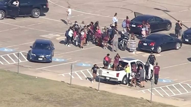 Schüler stehen vor der Timberview High School. Ein Schütze hat an einer Schule in Arlington im US-Bundesstaat Texas das Feuer eröffnet.