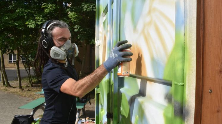 Gekonnt lässt André Haferkorn aus Lüneburg am Container auf dem Neuhauser Schulhof mit wenigen Sprühstößen ein Kunstwerk entstehen.