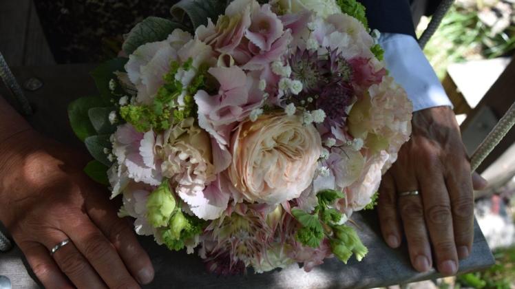 Zur Erinnerung an diesen Tag hat das Brautpaar später noch Bilder mit ihren schönen Blumen und den neuen Ringen in einem Gärtchen gemacht.