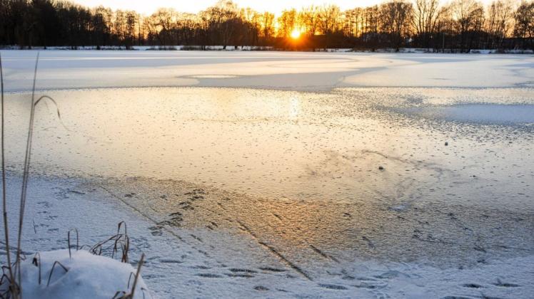 Der Rubbenbruchsee in der Abendsonne: Ein paar unerschrockener Zweibeiner haben sich schon auf das Eis getraut. Die Stadt Osnabrück warnt vor dem Betreten zugefrorener Gewässer.