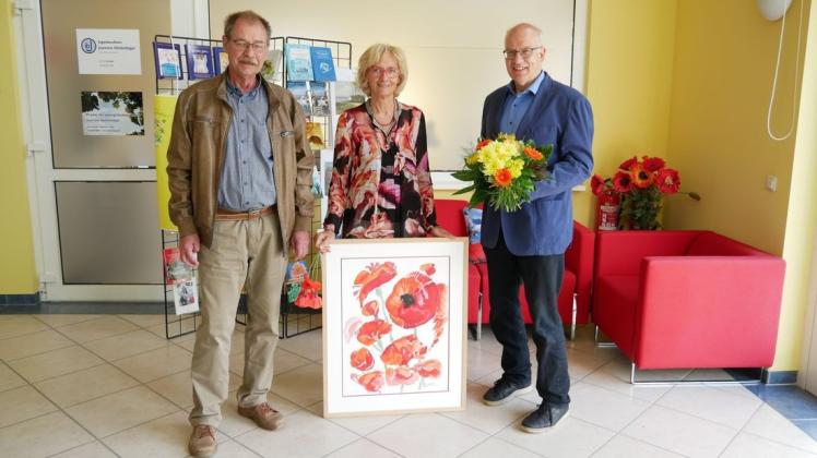 Ein besonderes Geschenk überreichten Wolfgang Vierow (l.) und Roland Methling (r.) an Angelika Kleinfeldt zu ihrem 25. Verlagsjubiläum.