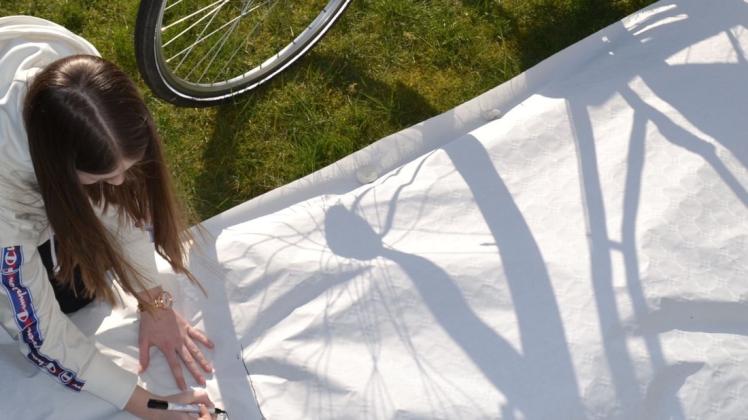 Die Sonne macht&apos;s möglch: Der Schatten des Fahrrades wird auf den Stoff geworfen und kann nachgezeichnet werden. Foto: Ilona Weyer