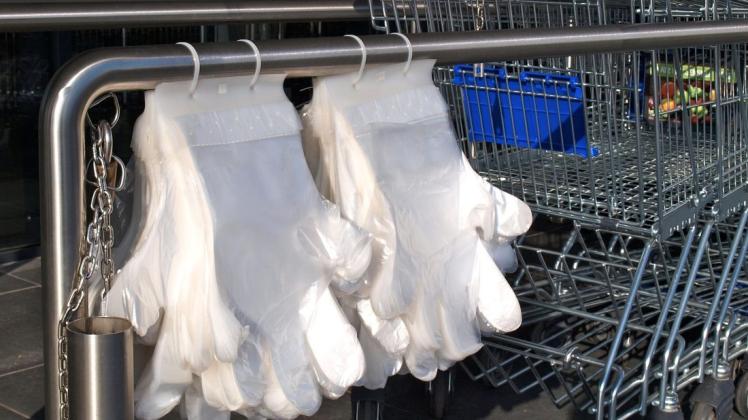 Riesige Handschuhe bietet eine Marktkette seinen Kunden als Virenschutz an. Foto: Conny Rutsch