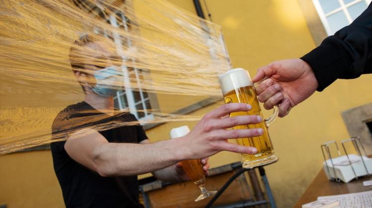 Mit Pilotenbrille und Mundschutz hinter einem Spuckschutz verkaufte Aushilfskraft Moritz am Montagabend Bier am Unikeller. Mit Pilotenbrille und Mundschutz hinter einem Spuckschutz verkaufte Aushilfskraft Moritz am Montagabend Bier am Unikeller.