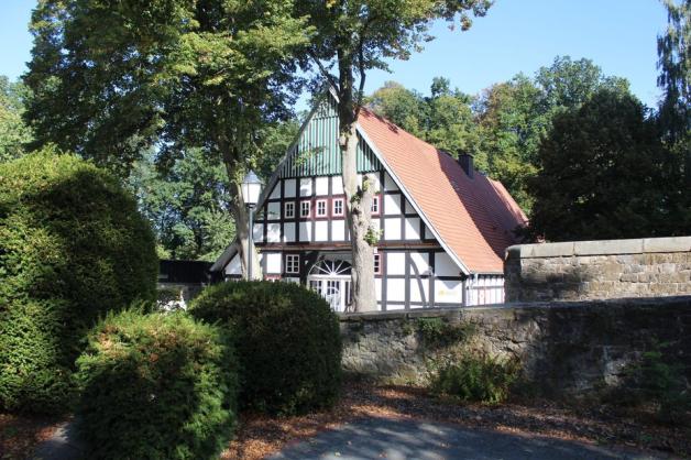 Geschützt unter Bäumen und hinter historischen Mauern steht das resturierte Heuerhaus der Burg Wittlage. Foto: Lars Herrmann