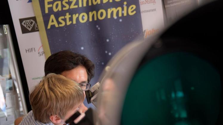 Jesse (7) schaut mit Papa Karl durchs Teleskop. Foto: Hermann Pentermann