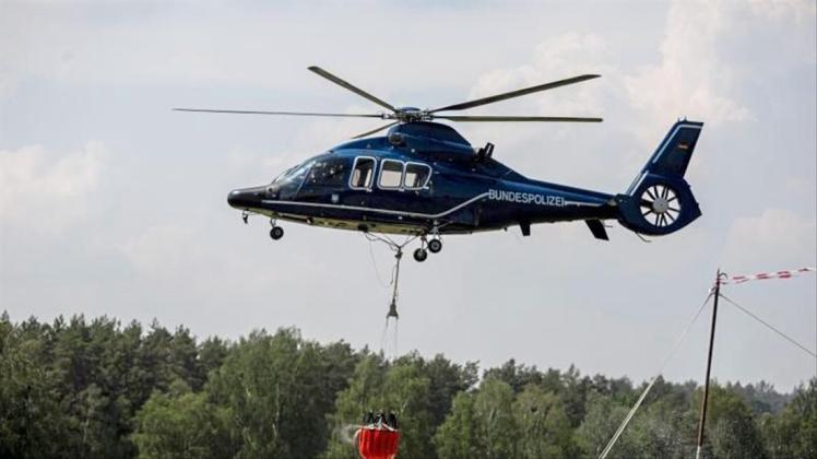 Ein Hubschrauber der Bundespolizei nimmt in Frankenförde Löschwasser auf. In Frankenförde bei Jüterbog befindet sich die Einsatzzentrale der Feuerwehr. 