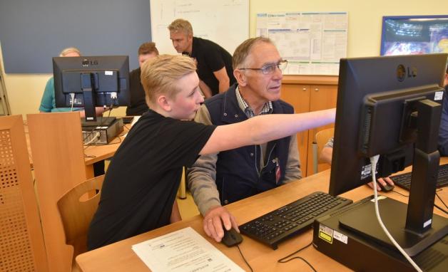 Siebtklässler Lars zeigt Gerold Wieting, wie man den Computer bedient. Foto: Christopher Bredow