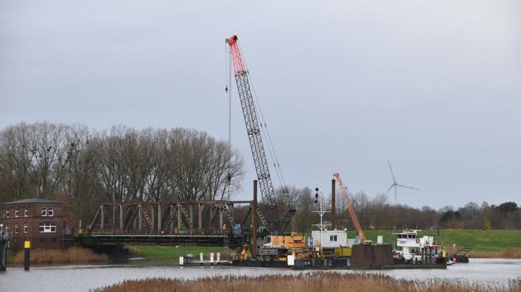 Am Dienstag wurden von einem Kran, der auf einem Ponton steht, Teile von der Eisenbahnbrücke auf der Seite der Stadt Weener gehoben.