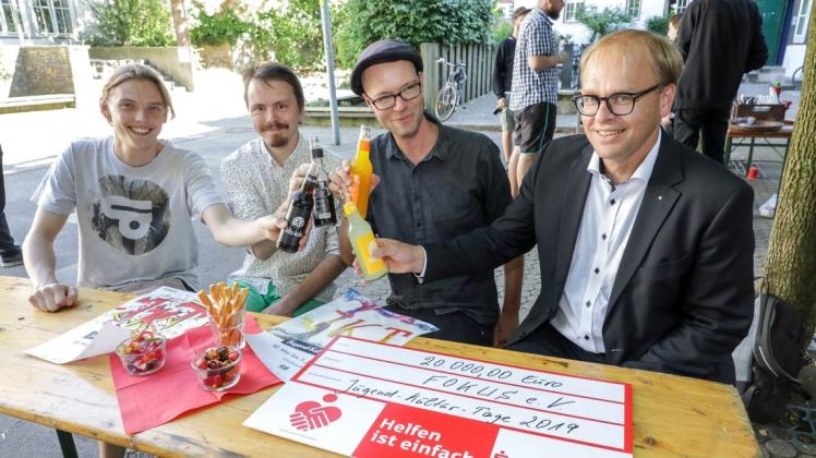 Die Stiftung der Sparkasse fördert die Jugend-Kultur-Tage. Bei der symbolischen Scheckübergabe im Haus der Jugend stießen (selbstverständlich alkoholfrei) an (von links): Steffen Tobergte, Oliver Falkenberg und Marco Gausmann vom Fokus-Team und Ralf Hellige als Vertreter der Stiftung. Foto: Jörn Martens