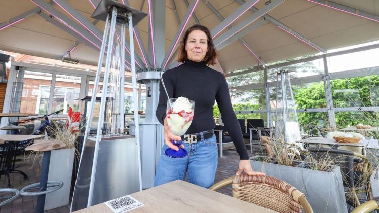 Katja Blume vom Eiscafé Paulini freut sich, dass in ihre Außengastronomie in Ganderkesee-Heide wieder Leben einkehrt. Mit Riesenschirm und Heizstrahlern ist das Eiscafé gegen Wind und Wetter gewappnet.