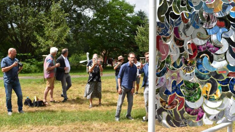 Vernissage: Die Regenbogenfahne aus CD-Fragmenten ist die jüngste Arbeit von Christian Reder (2.v.r.), die den Garten des Kunst-Wasser-Werks schmückt.