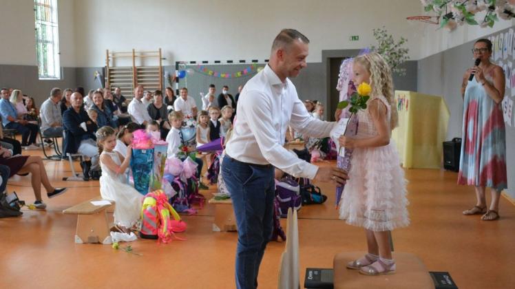 Symbolisch die Stufe in die Schule genommen: Mia erhält von Papa Michael Schneider ihre Schultüte.