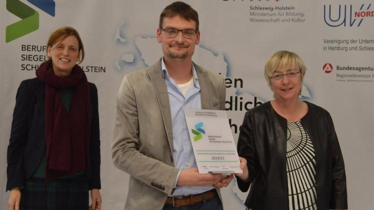 Ministerin Karin Prien (links) übergab die Zertifizierung an Schulleiterin Ute Freund und Wi-Po- und Geschichtslehrer Christian Hemkendreis.