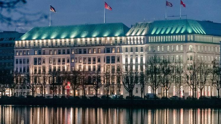 Die Lichter des hell erleuchteten 5-Sterne-Luxushotels "Fairmont Hotel Vier Jahreszeiten", erbaut im Jahr 1897, spiegeln sich im Wasser der Binnenalster.