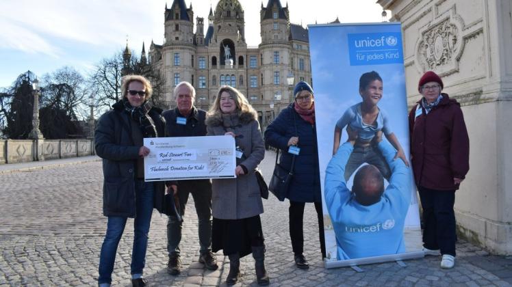 Spendenübergabe am Schloss: „Mr. Rod“ alias Marco Wölfer (l.) überreicht an Barbara Seiler (m.) von der Schweriner Unicef-Gruppe einen Scheck über 3640 Euro für das Kinderhilfswerk der Vereinten Nationen.