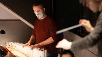 Philipp Marguerre spielt Glasharmonika im Orchestergraben des Osnabrücker Symphonieorchesters