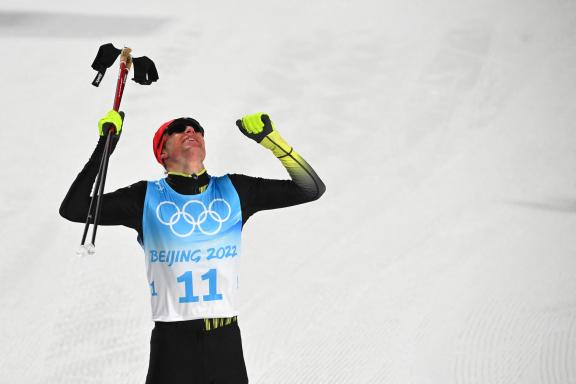 Germany&apos;s Vinzenz Geiger celebrates after crossing the finish line to win the cross-country race of the Nordic Combined men&apos;s individual normal hill/10km event during the Beijing 2022 Winter Olympic Games at the Zhangjiakou National Cross-Country Skiing Centre on February 9, 2022. (Photo by Pierre-Philippe MARCOU / AFP)