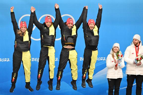 (L to R) Germany&apos;s Johannes Ludwig, Germany&apos;s Natalie Geisenberger and Germany&apos;s Tobias Wendl and Germany&apos;s Tobias Arlt celebrate after winning the luge team relay event at the Yanqing National Sliding Centre during the Beijing 2022 Winter Olympic Games in Yanqing on February 10, 2022. (Photo by Joe KLAMAR / AFP)