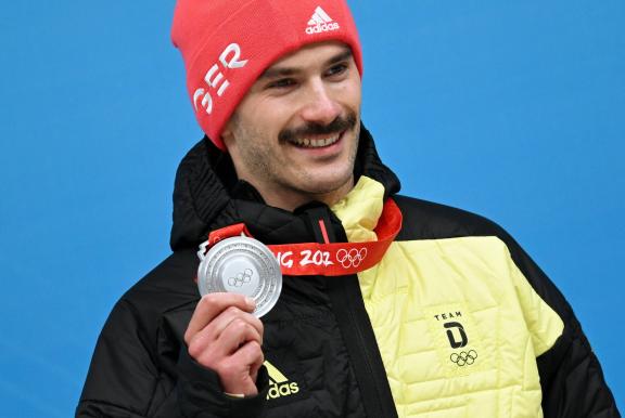 China Olympics 2022 Medal Ceremony 8111658 11.02.2022 Silver medalist Germany s Axel Jungk celebrates on the podium dur