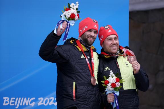 BEIJING, CHINA - FEBRUARY 15, 2022: Athletes Christoph Hafer (L) and Matthias Sommer of Germany celebrate their bronze