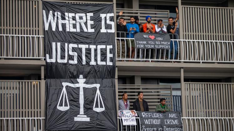 Protesters gather to support asylum seekers detained at the Kangaroo Point Central Hotel in Brisbane, Sunday, June 28, 2020. (AAP Image/Glenn Hunt) NO ARCHIVING