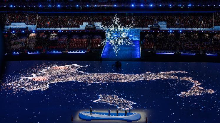 BEIJING, CHINA   FEBRUARY 20, 2022: The snowflake-shaped Olympic cauldron and the map of Italy are seen at the closing