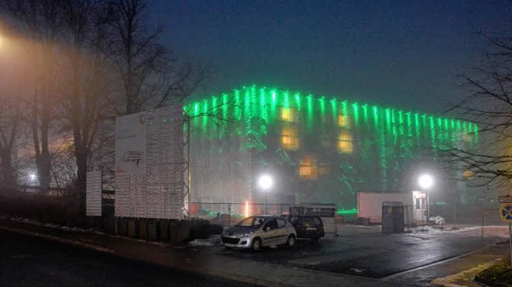 Der Klinik-Neubau an der St. Jürgener Straße: Der dreiteilige Gebäudekomplex ist eingehüllt in Kunststoffplanen, die nachts grün illuminiert werden. Darunter wird schon seit Wochen der Putz erneuert.  