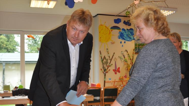 Im Wahlbüro 10 in Göldenitz gibt Wahlleiterin Ute Guhse die Wahlurne frei, damit der alte und neue Bürgermeister Axel Wiechmann seine Stimme abgeben kann.  
