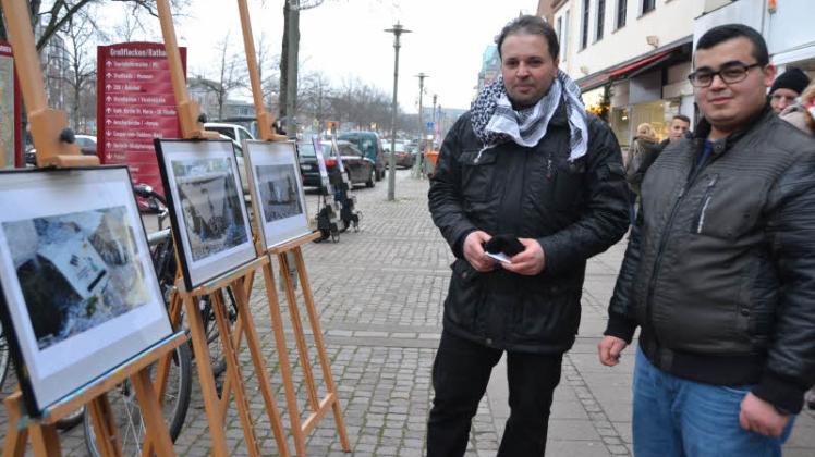 Ibrahim Ortacer (links) vom Friedensforum und Noureddin Soliman betrachten Graffiti aus syrischen Kriegsgebieten.