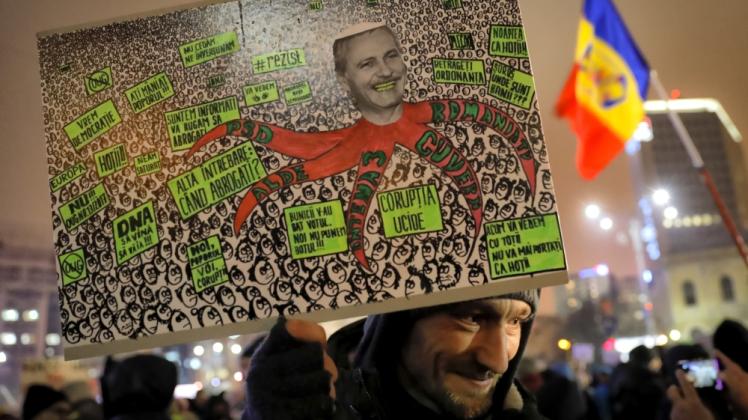 Massenproteste: Demonstrant in Bukarest mit einem Plakat, das Regierungsparteichef Dragnea als Krake zeigt 