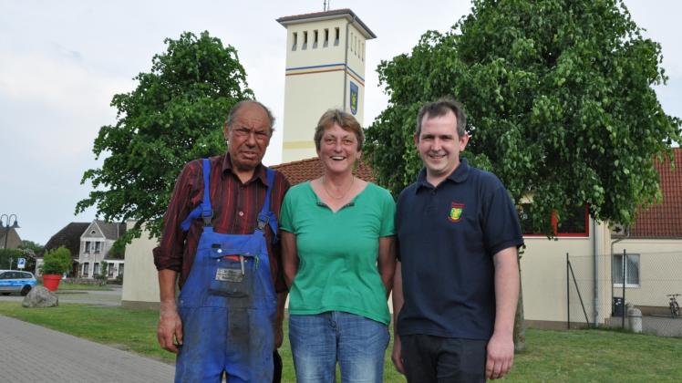 Das Banzkower Feuerwehrjubiläum wird rund um den Schlauchturm gefeiert. Alt-Wehrführer Manfred Dähn (l.), Bürgermeisterin Irina Berg und Wehrführer Sven Pinnow laden ein.  