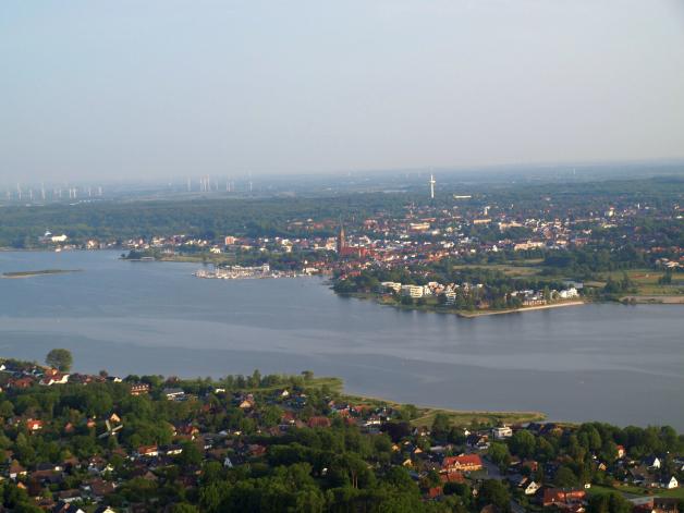 Hinter Fahrdorf und der Schlei präsentiert sich Schleswig mit Dom, Fernsehturm und den Gebäuden im Stadtteil Auf der Freiheit.