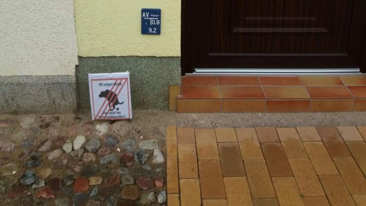 Das Schild vor dem Eingang  soll Kot auf der Straße verhindern.  