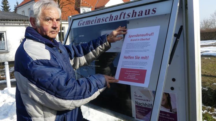 Vor dem Gemeinschaftshaus, an Schulen und Geschäften in Sanitz bringt Dietmar Kielmann das Plakat mit dem Spendenaufruf für die Brandopfer an. 