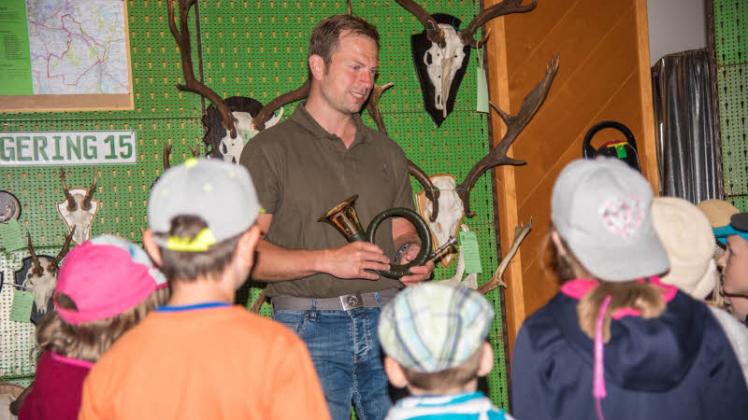 Norman Stoll erklärt den Kinder das Jagdhornblasen. 