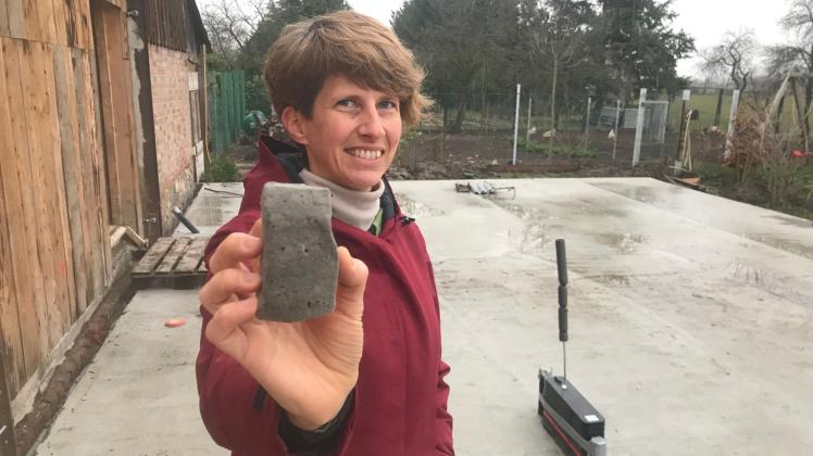 Angekommen in Brandenburg: Katrin Zabel zeigt den Baustoff aus Altglas, der das Fundament für ihr neues Haus bildet. Am Oderbruch schätzt die 46-jährige Mutter von zwei Kindern das Langsame, den weiten Blick und die Ruhe.