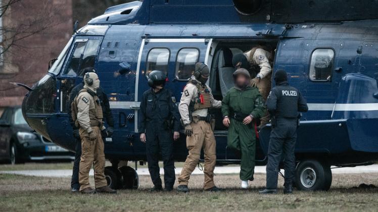 Beamte der Bundespolizei führen einen mutmaßliche Terrorverdächtigen aus einem Helikopter.