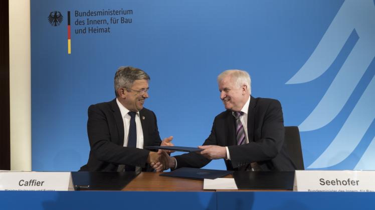 Tauschen die unterzeichneten Urkunden aus: Landesinnenminister Lorenz Caffier und Bundes- innenminister Horst Seehofer