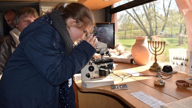 Nur durchs Mikroskop zu erkennen: Amélie blickt auf eine der kleinsten Bibeln der Welt. 