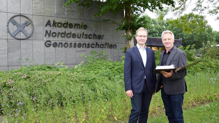 Guido Wendt (links) und Guido Froese vor einem Gebäude des Genossenschaftsverbandes.