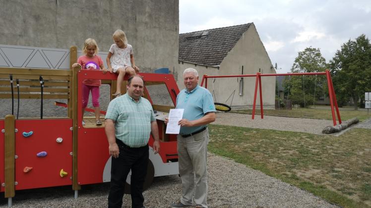 Am Spielplatz in Dargardt kann es mit der Umgestaltung weitergehen. Bürgermeister Udo Staeck überreichte dem Bürgervereinsvorsitzenden Bodo Burmeister den Fördermittelbescheid. 