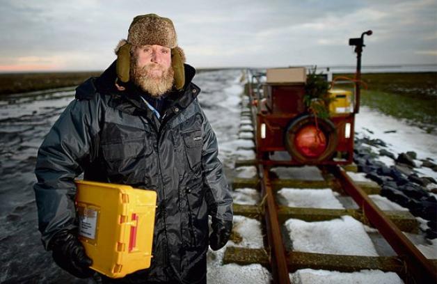 Der Postschiffer bringt seit Jahrzehnten Weihnachtsgeschenke auf die nordfriesischen Halligen:  Fiede Nissen kämpft sich bei Sturm und Eis mit seiner Lore durchs Watt.  Foto: dpa 
