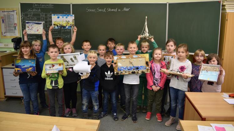 Stolz präsentieren diese Erst- und Zweitklässler der Sternberger Grundschule ihre Modelle im Bastelwettbewerb.