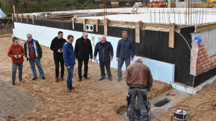 Auf die Minute wird der Beton angerührt, damit Bürgermeister Klaus Draeger und Architekt Mathias Redmann gemeinsam eine Zeitkapsel im Fundament einbetonieren können.