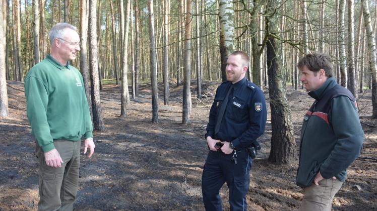 Besprechung am Ort des Waldbrandes von Montag: Forstamtsleiter Dr. Holger Voß, Polizeioberkommissar Tim Dommer und Revierförster Reno Nerling (v.l.n.r.). 