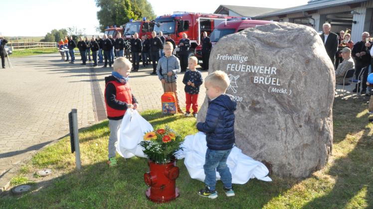 Enthüllt: Fiete und Max zogen das Tuch vom neuen Gedenkstein vor dem Gerätehaus der Freiwilligen Feuerwehr Brüel. 