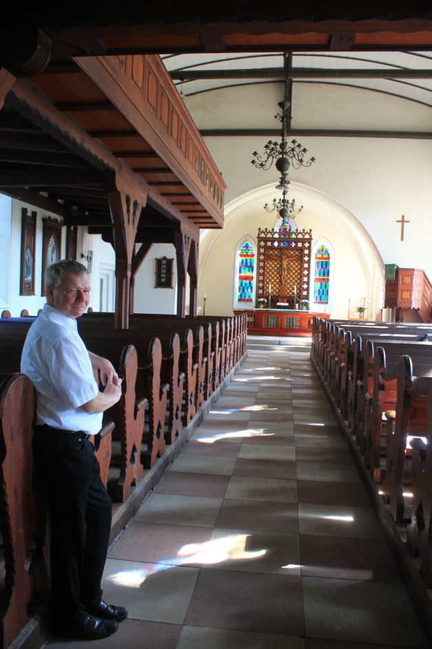 Mit Blick auf den besonderen Altar: Pastor Christoph Tuttas ist stolz darauf, dass die Kirche so gut erhalten ist.  